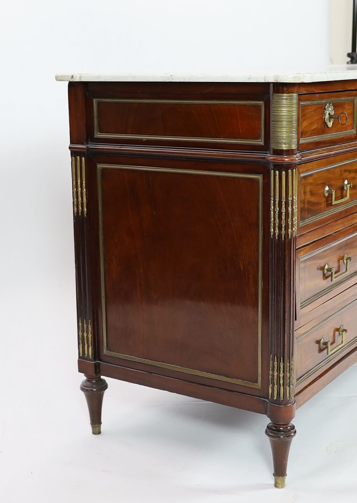 A 1790's French Directoire period brass mounted mahogany commode, W.146cm D.65cm H.95cm